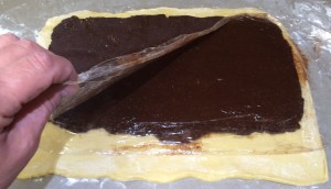 Applying chocolate cinnamon filling to dough