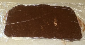 Chocolate Cinnamon Filling between sheet of plastic wrap