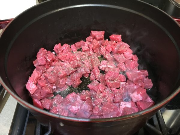 Diced Beef Round cooking in cast iron pot.