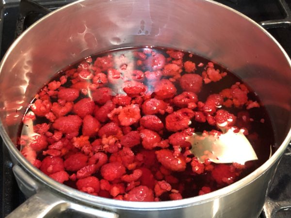 Combine infused berry vinegar and apple juice together in sauce pan.