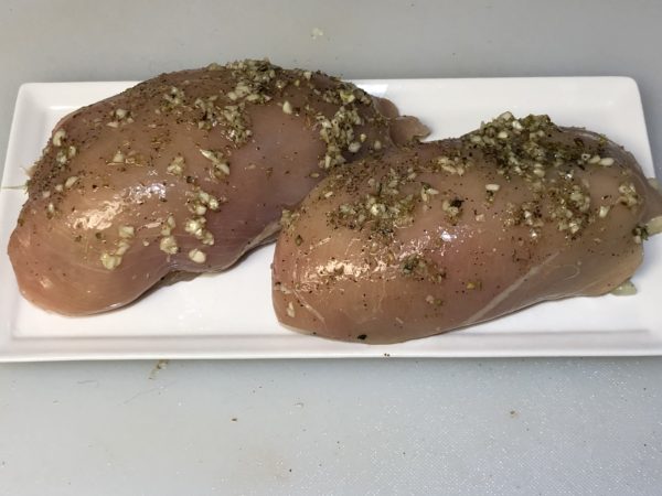 Rolled Stuffed chicken breast, sprinkle with Greek Seasoning, Oregano, Kosher Salt and Black Pepper. Spray with Olive Oil using EVO Sprayer to get an even coating of Olive Oil over all the chicken.