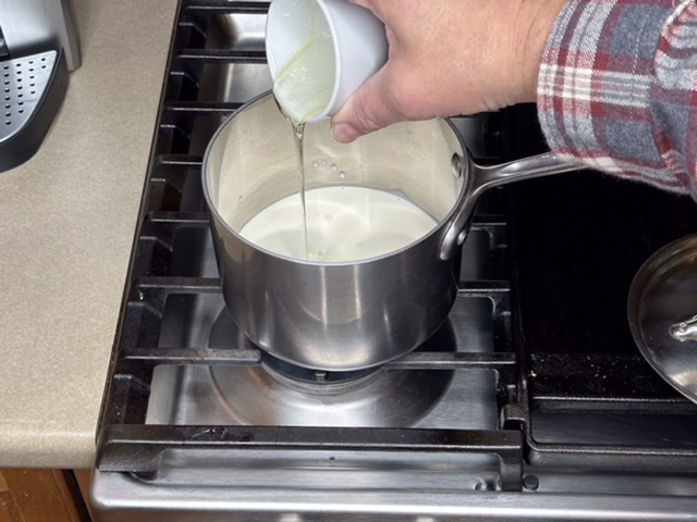 Pouring corn syrup into sauce pan with heavy cream