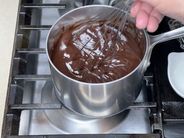 Whisking all ingredients for Dark Chocolate Godiva Truffles filling until smooth and completely combined.
