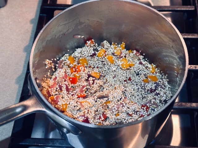 Adding quinoa to the sweated vegetables