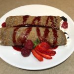 Plated Buckwheat Crepes with Fresh Berries and whipped cream.