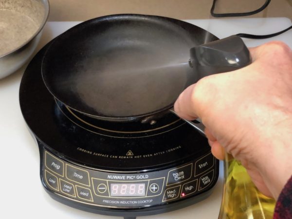 Spray the skillet with oil.