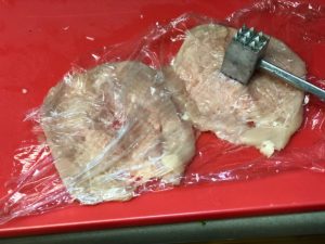 Pound the chicken breast covered with plastic wrap and flattened with meat mallet.