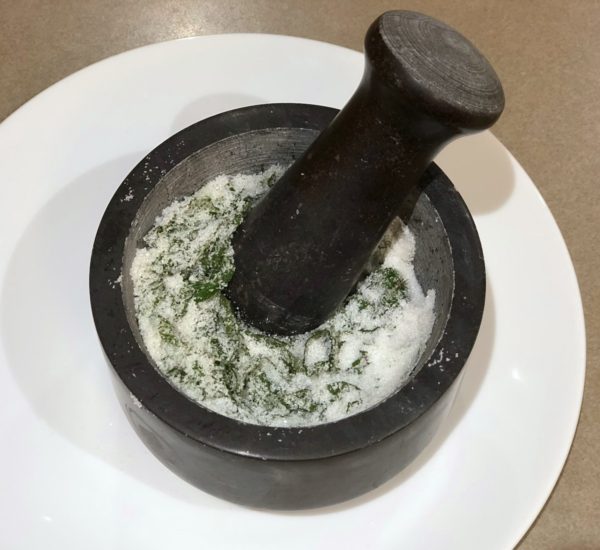 Crushing Chocolate Mint leaves and sugar with Mortar & Pestle.