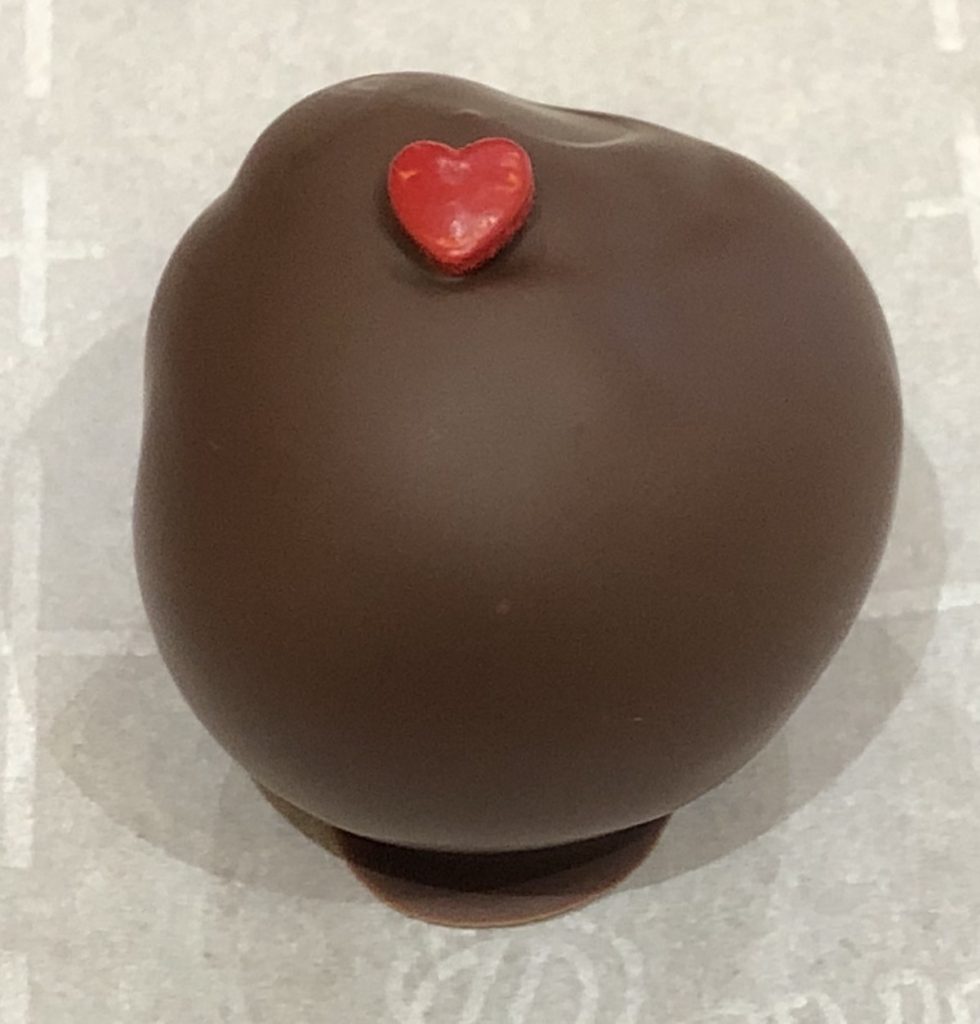 Picture of Hot Cinnamon Truffle that has been dipped in Dark Couverture Chocolate garnished with red heart