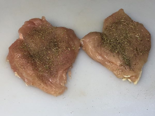 Butterfly boneless chicken breasts and sprinkle with Greek Seasoning, Oregano, Salt and Pepper.