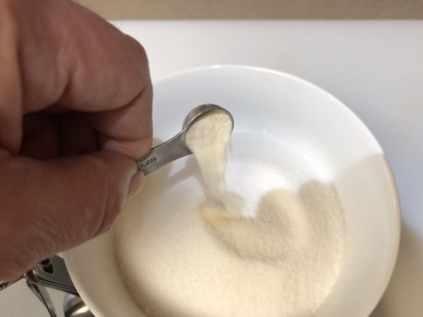 Combine sugar and xantham gum together in bowl