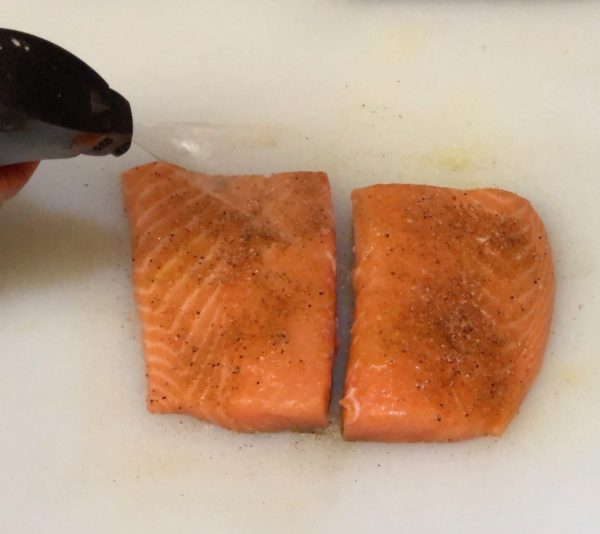 Spray Salmon Filets with olive oil using the EVO Sprayer