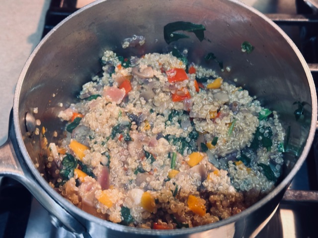 Stirring all the quinoa vegetable pilaf ingredients together